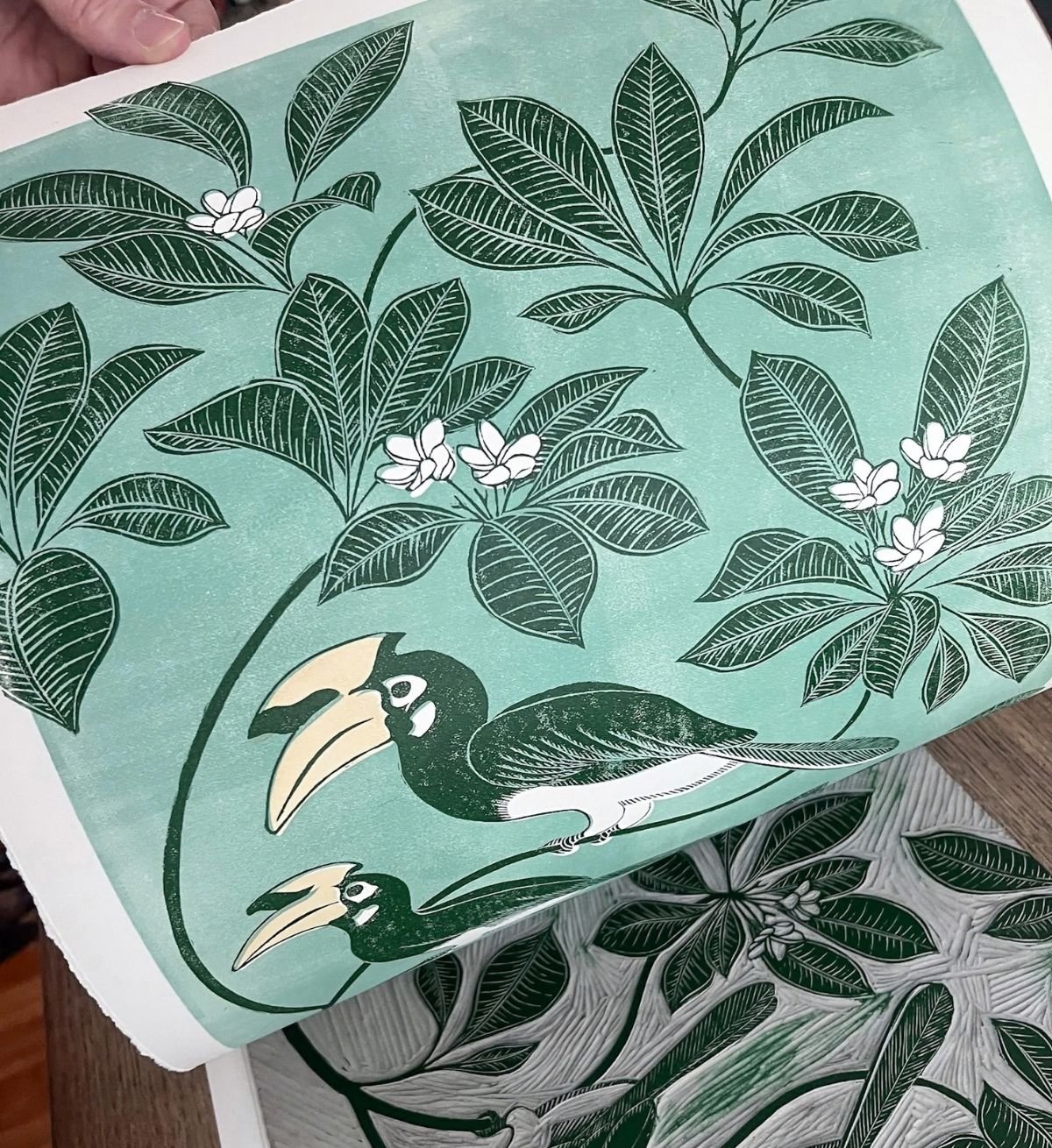 Lou Lauwerys hand-printed linocut of hornbills among tropical leaves