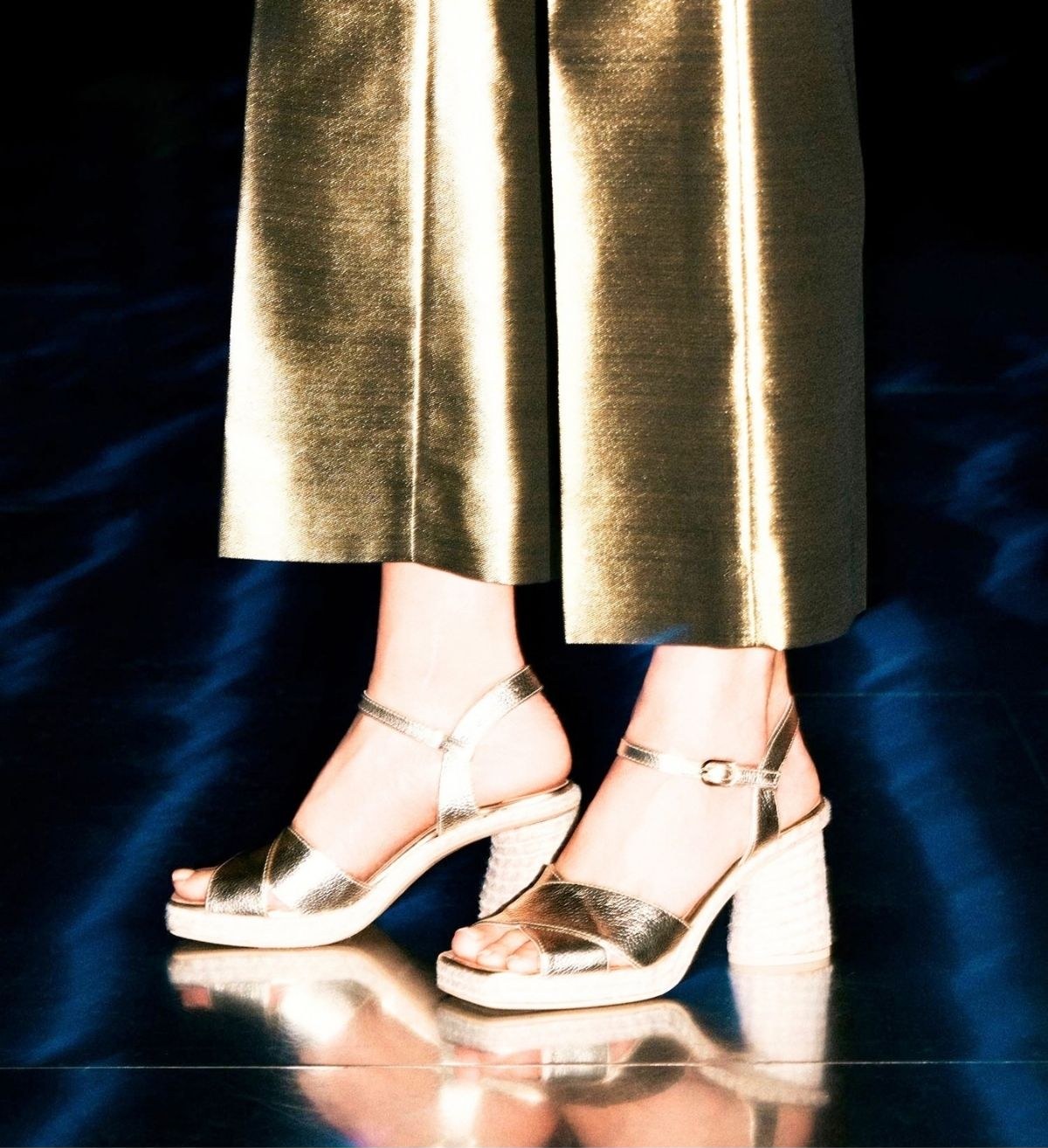 A model wearing gold Bastide Colombe espadrille sandals